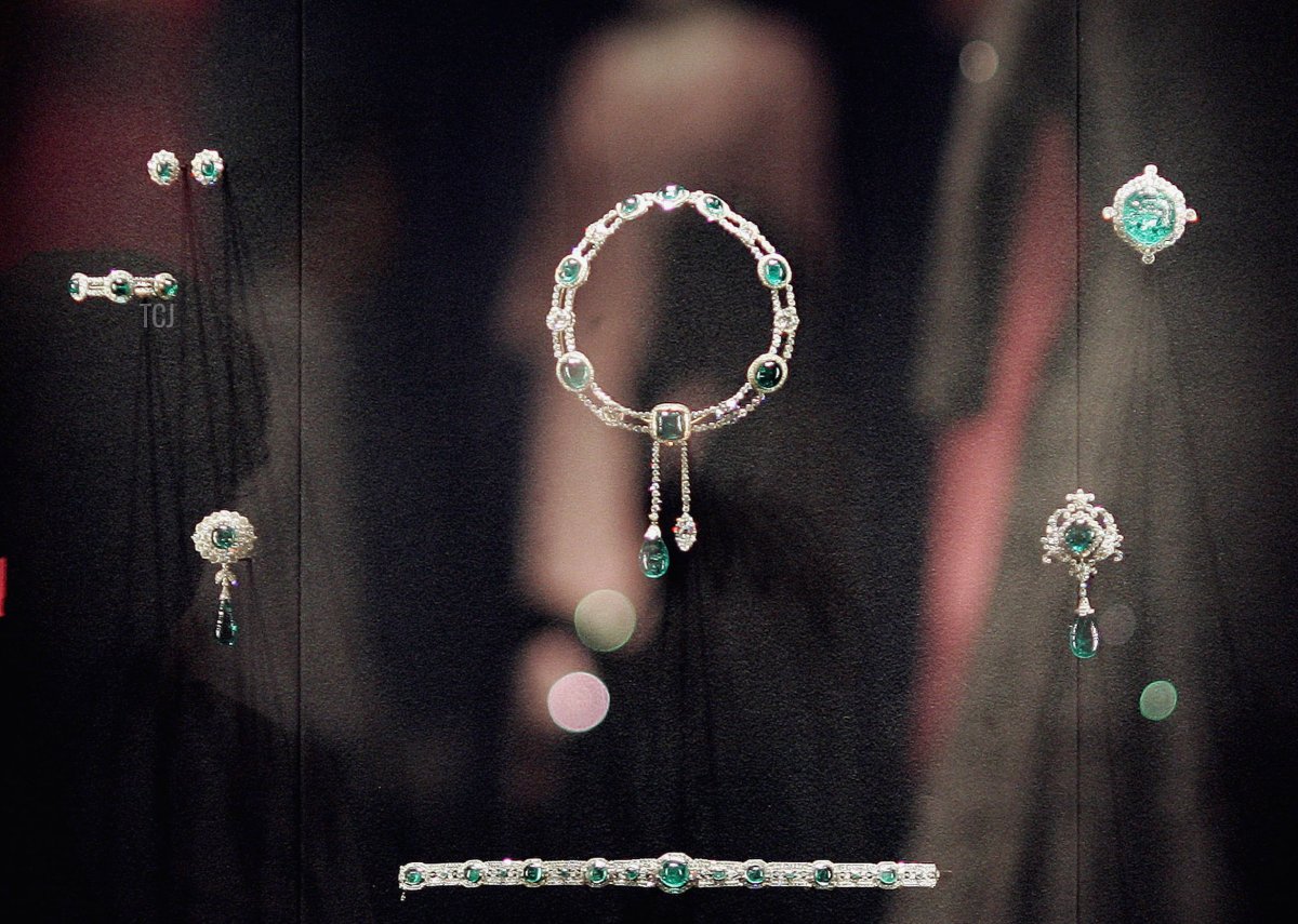 Queen Elizabeth II's dresses are reflected in a glass case displaying The Vladimir Tiara and The Delhi Durbar necklace at Buckingham Palace on July 25, 2006 in London