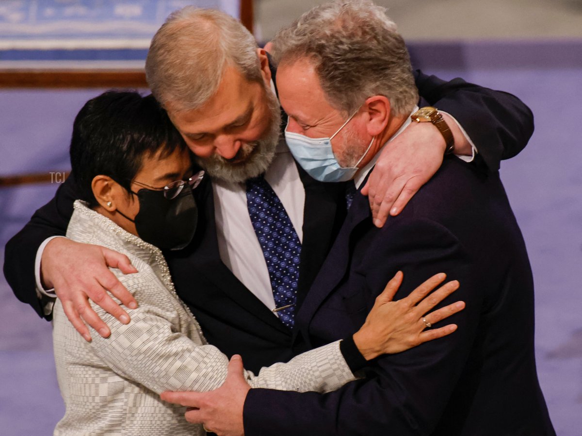 I premi Nobel per la Pace, Maria Ressa delle Filippine (a sinistra), Dmitry Muratov della Russia (al centro) e David Beasley del Programma Alimentare Mondiale, vincitore del Premio Nobel per la Pace 2020, si abbracciano dopo la cerimonia di premiazione del Premio Nobel il 10 dicembre 2021 a Oslo