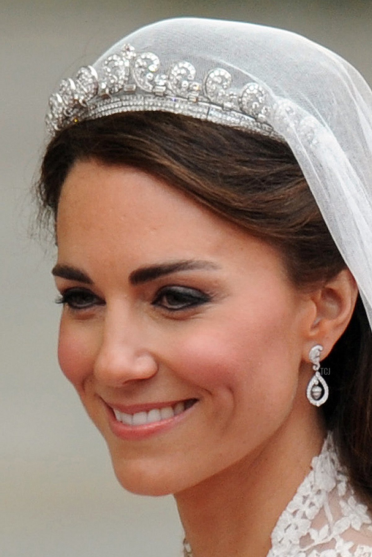 Britain's Prince William's wife Kate, Duchess of Cambridge, smiles as they travel in the 1902 State Landau carriage along the Processional Route to Buckingham Palace, in London, on April 29, 2011