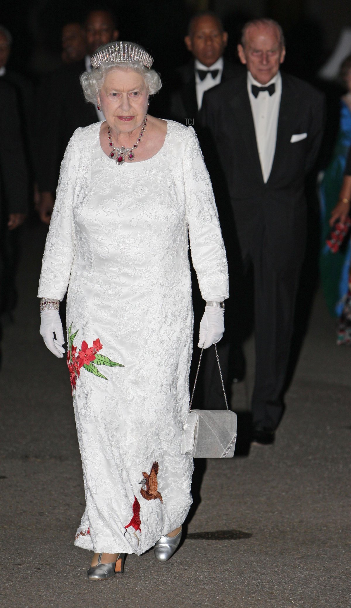 Queen Elizabeth II and the Duke of Edinburgh walking in the grounds of President George Maxwell Richards' official residence before a State Dinner, 26 Nov 2009