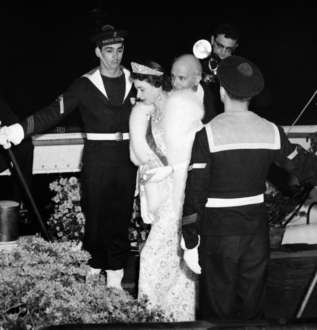 La regina Elisabetta II seguita dal presidente francese Rene Coty (C) sale a bordo della barca 'Borde Fretigny' a Parigi durante una visita di stato in Francia il 10 aprile 1957