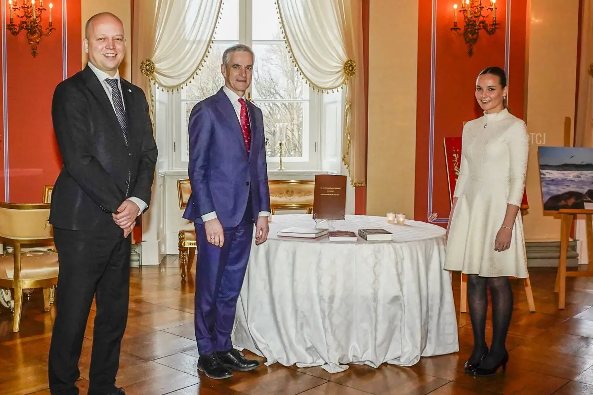 Princess Ingrid Alexandra of Norway (R) poses with Norwegian Prime Minister Jonas Gahr Stoere (C) and Norwegian Finance Minister Trygve Slagsvold Vedum who presented her with a hardcover edition of the Constitutional Amendment of May 29, 1990 and the books 'Eufemia', 'Landet mot nord' and a book on Norwegian women's history on her 18th birthday, in Oslo on January 21, 2022