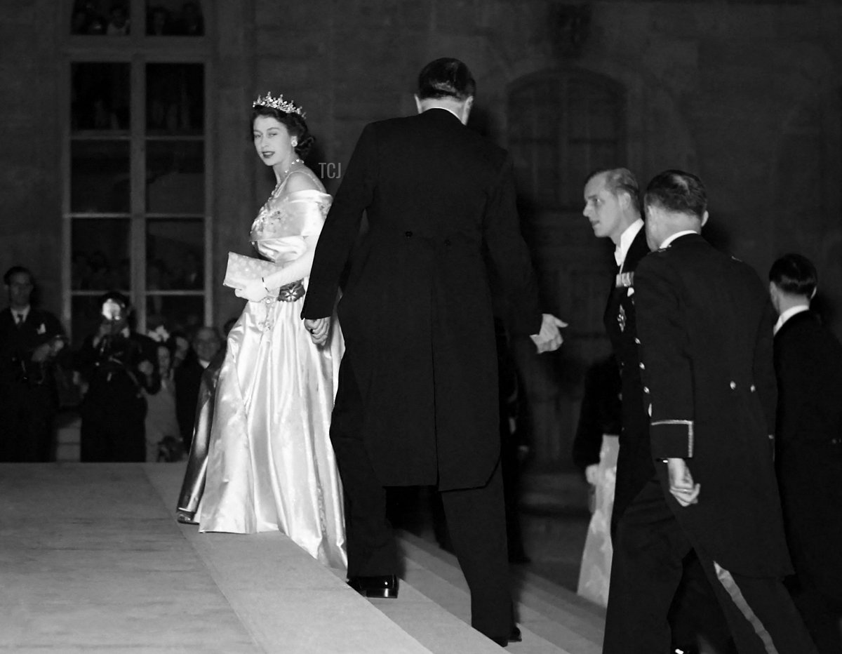 La Principessa Elisabetta d'Inghilterra, indossando un abito da sera e una tiara, accompagnata dal marito Filippo, Duca di Edimburgo, arriva al Palazzo dell'Elysee il 14 maggio 1948