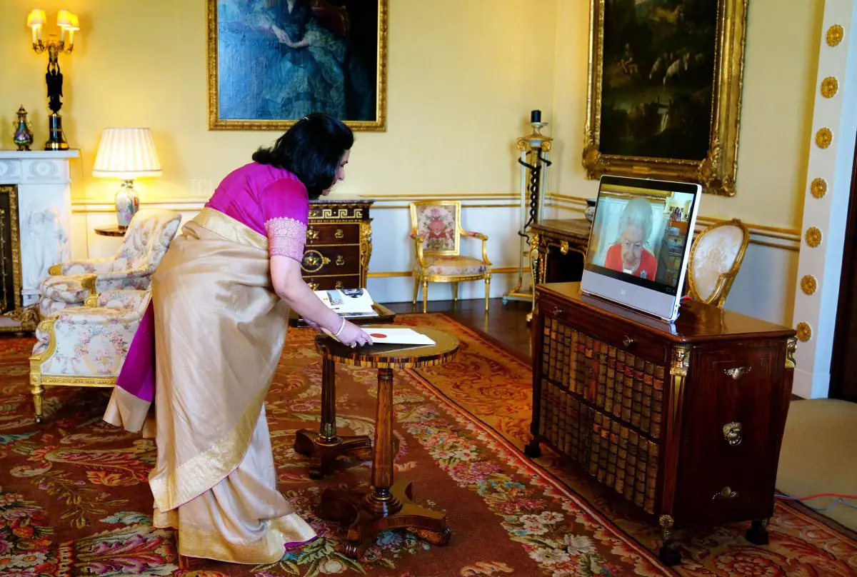 La Regina del Regno Unito, Elisabetta II (a destra), appare su uno schermo tramite videolink da Windsor Castle, durante un incontro virtuale con il Commissario Alto dell'India nel Regno Unito, Gaitri Issar Kumar, a Buckingham Palace a Londra l'8 marzo 2022