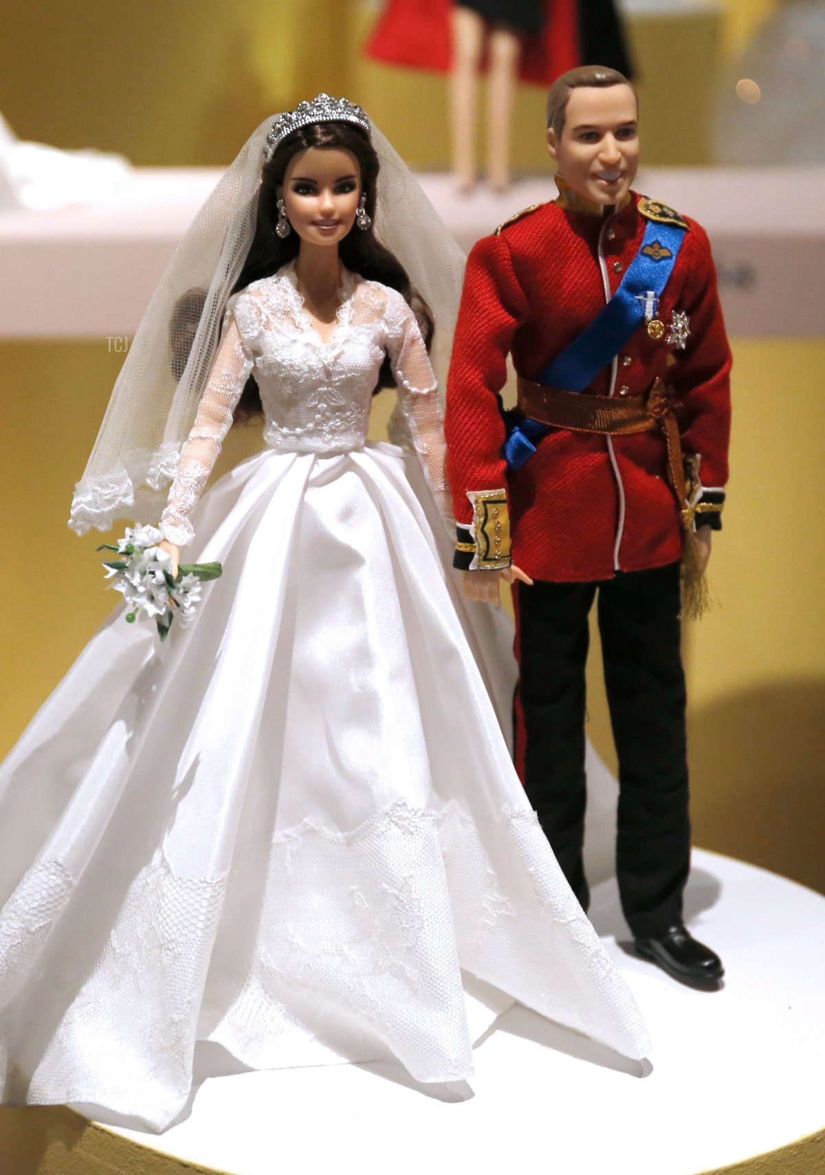 A photo taken on March 10, 2016 in Paris shows Barbie dolls representing Britain's Prince William, Duke of Cambridge (R) and Catherine Middleton Duchess of Cambridge, during the exhibition 