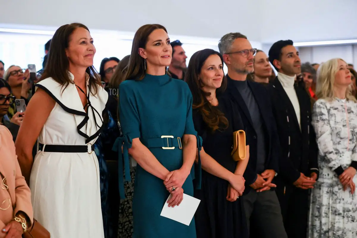 Britain's Catherine, Duchess of Cambridge, and CEO of the British Fashion Council (BFC), Caroline Rush, stand in the audience and listen to people speak during 