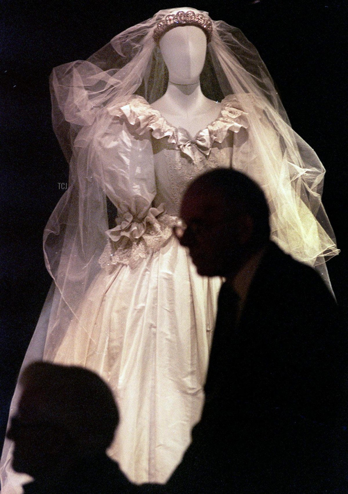 Visitatori passano accanto al vestito da sposa indossato da Diana, Principessa del Galles il 29 Giugno 1999 durante il giorno di apertura della mostra per celebrare la sua vita presso il suo luogo d'origine, Althorp Park, che è anche il sito dove è sepolta