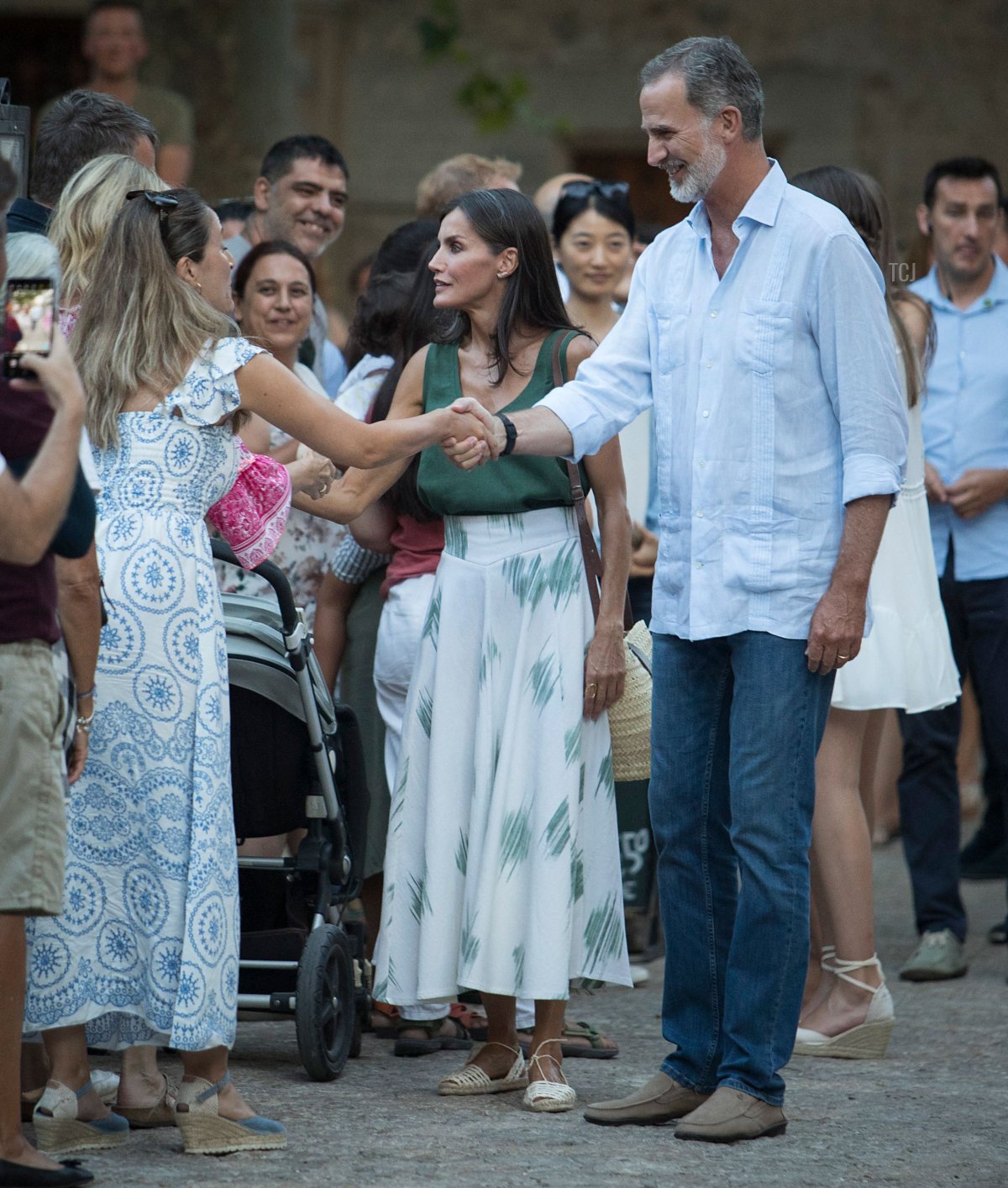 La Regina Letizia di Spagna (C) e il Re Felipe VI di Spagna (D) stringono la mano alle persone durante una visita alla Cartoixa di Valldemossa sull'isola di Maiorca durante le vacanze estive nei Baleari il 1 agosto 2022