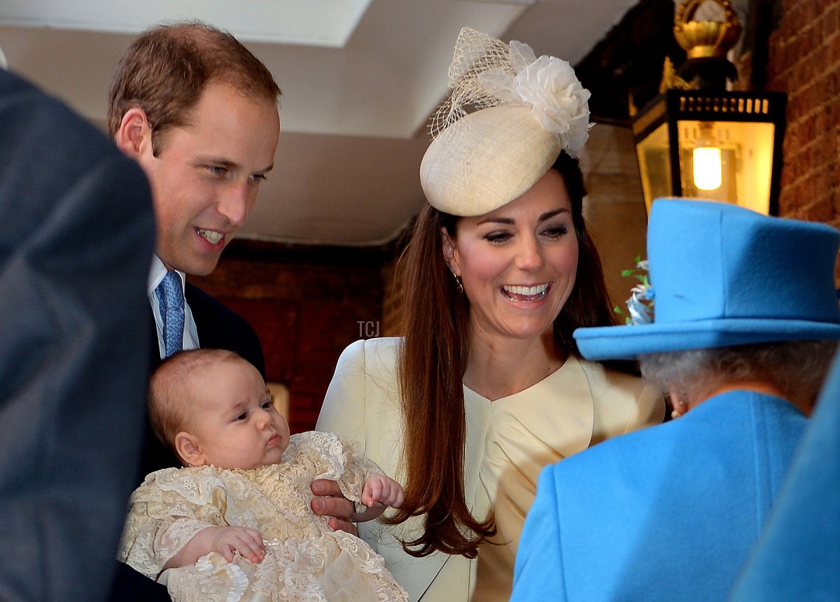 Il Principe William, Duca di Cambridge e sua moglie Catherine, Duchessa di Cambridge, parlano con la Regina Elisabetta II mentre tengono il loro figlio Principe Giorgio di Cambridge nella Cappella Reale a St James's Palace a Londra il 23 ottobre 2013, all'arrivo per il battesimo del principe di tre mesi