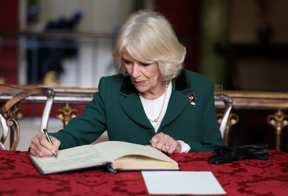 Camilla, Queen Consort signs the visitor book as she visits the Mansion House in Doncaster during an official visit to Yorkshire on November 9, 2022 in Doncaster, England