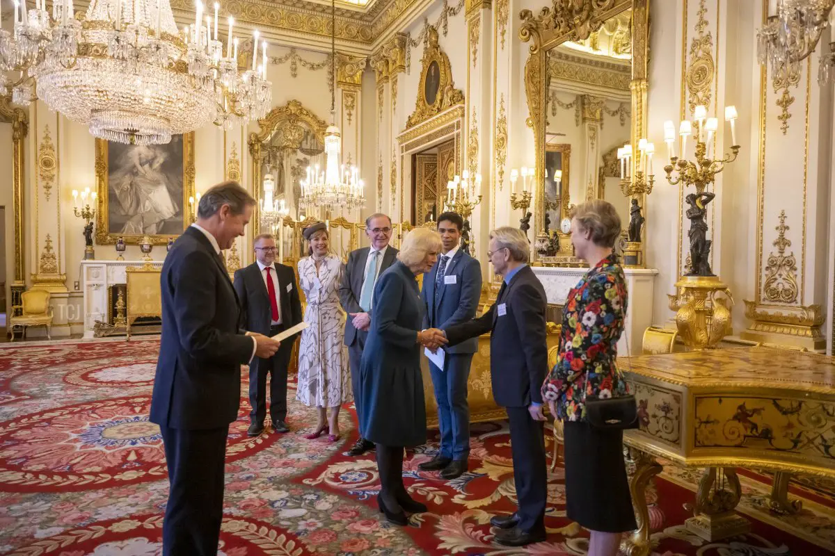 Camilla, Queen Consort is introduced to the Chief Executive of the RAD, Tim Arthur, President of the RAD, Dame Darcey Bussell, renowned dancer and former recipient of the award, Carlos Acosta, the 2022 recipient of the The Queen Elizabeth II Coronation Award, Mikhail Baryshnikov, in recognition of his immense contribution to ballet and the wider world of dance, and his wife Lisa Rinhart before the presentation in the White Drawing Room at Buckingham Palace on November 16, 2022 in London, England