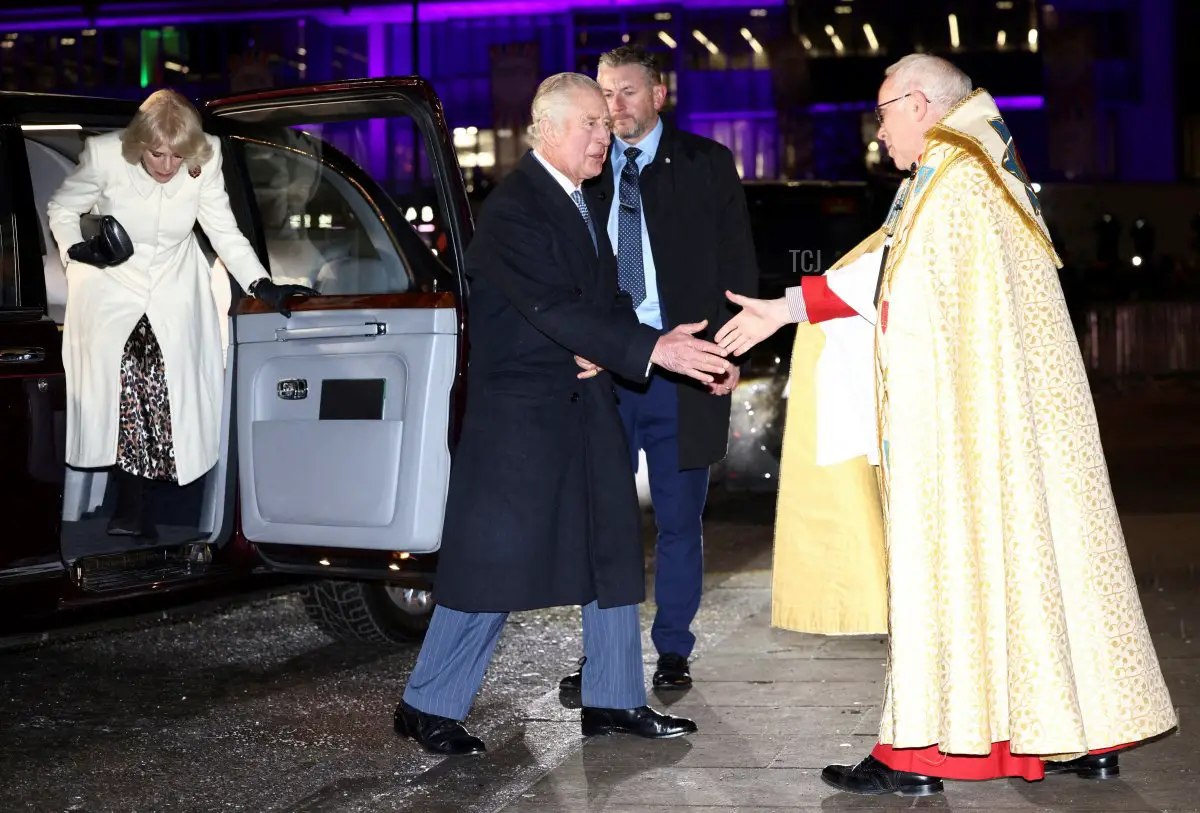 Britain's King Charles III (C) is welcomed by Dean of Westminster David Hoyle upon arrival with Queen Consort Camilla (L) to attend the 'Together At Christmas Carol Service' at Westminster Abbey, in London, on December 15, 2022