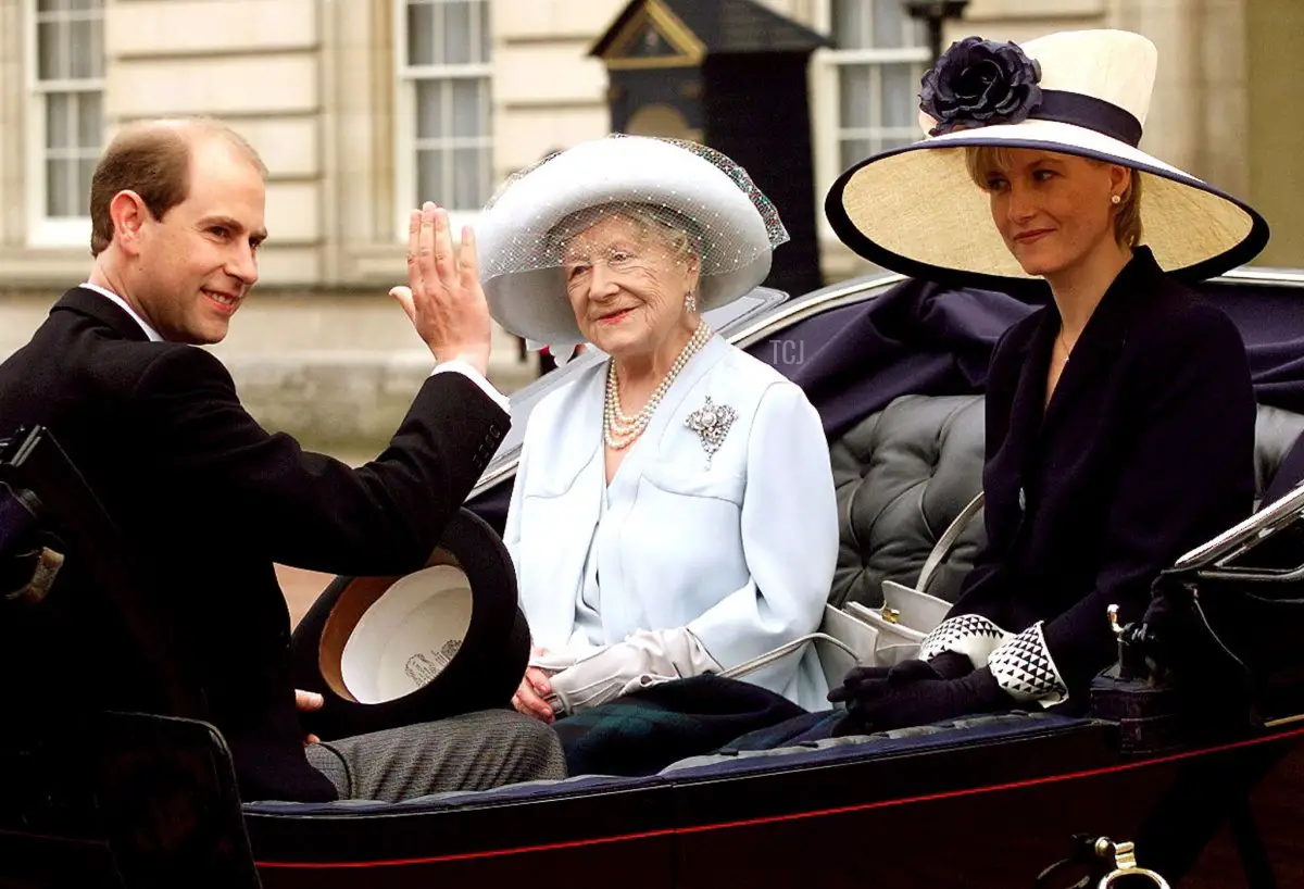 Il Principe Edward del Regno Unito saluta i ben desideranti mentre la sua futura moglie Sophie Rhys Jones e la Regina Madre osservano mentre viaggiano in una carrozza aperta trainata da cavalli durante la cerimonia di Trooping the Colour a Londra, sabato 12 giugno 1999 (DYLAN MARTINEZ/POOL/AFP via Getty Images)