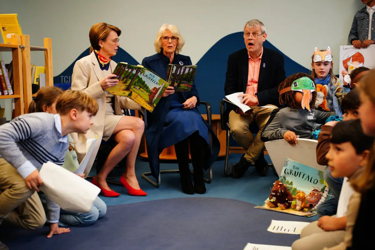 La regina Camilla legge The Gruffalo con la First Lady Elke Buedenbender e Axel Scheffler, l'illustratore del libro per bambini, durante una visita alla Rudolf Ross Grundschule il 31 marzo 2023 ad Amburgo, Germania (Ben Birchall - Pool/Getty Images)