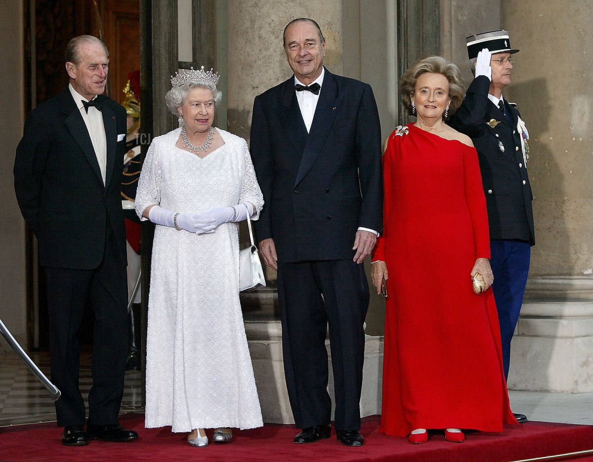 Queen Elizabeth II and the Duke of Edinburgh are welcomed to the Elysee Palace in Paris by President Jacques Chirac and his wife, Bernadette, ahead of a state dinner celebrating the centenary of the Entente Cordiale, April 5, 2004 (PATRICK KOVARIK/AFP via Getty Images)