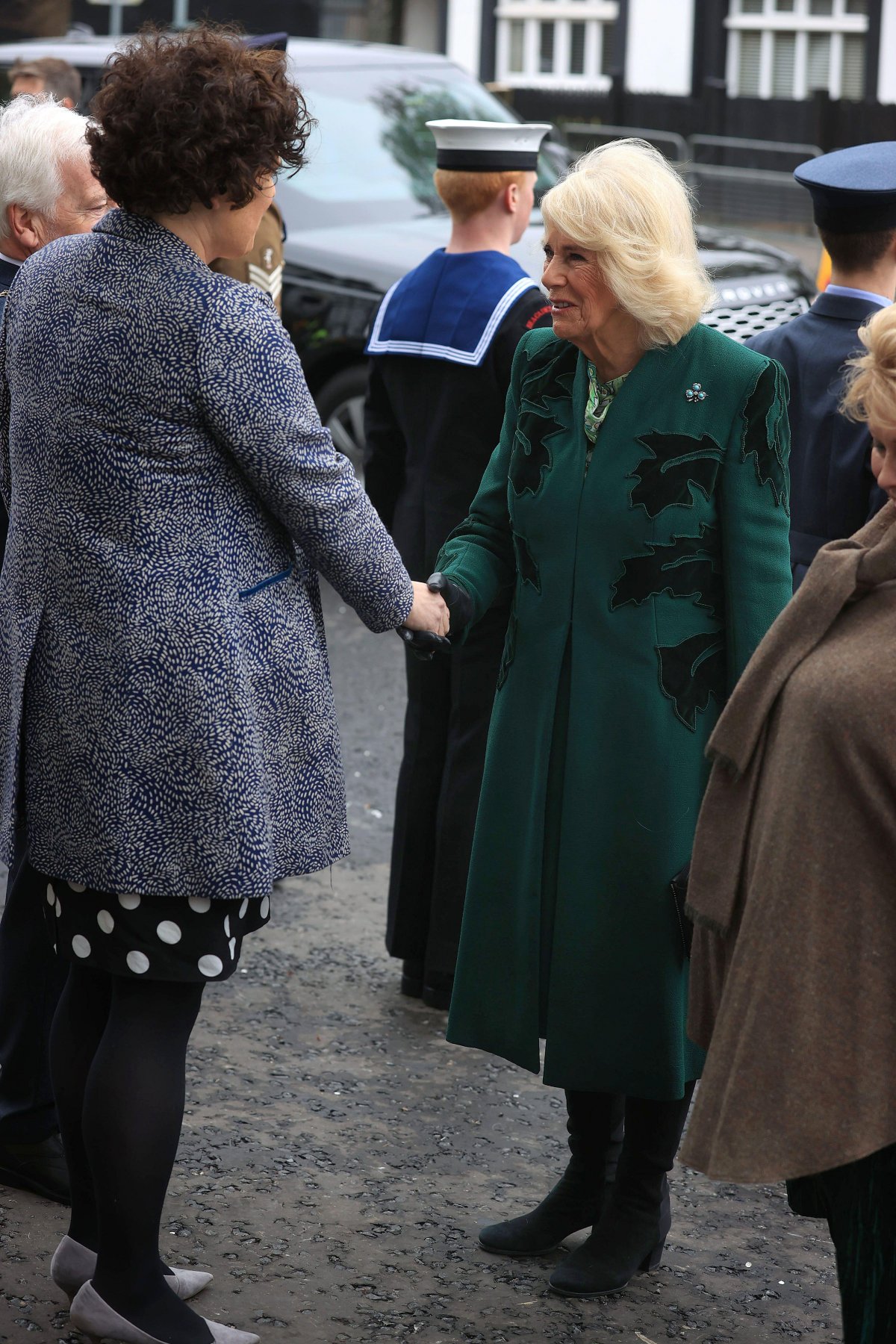 Queen Camilla of the United Kingdom is greeted by Claire Hanna, MP for Belfast South, during a visit to Lisburn Road in Belfast on March 21, 2024 (Liam McBurney/PA Images/Alamy)