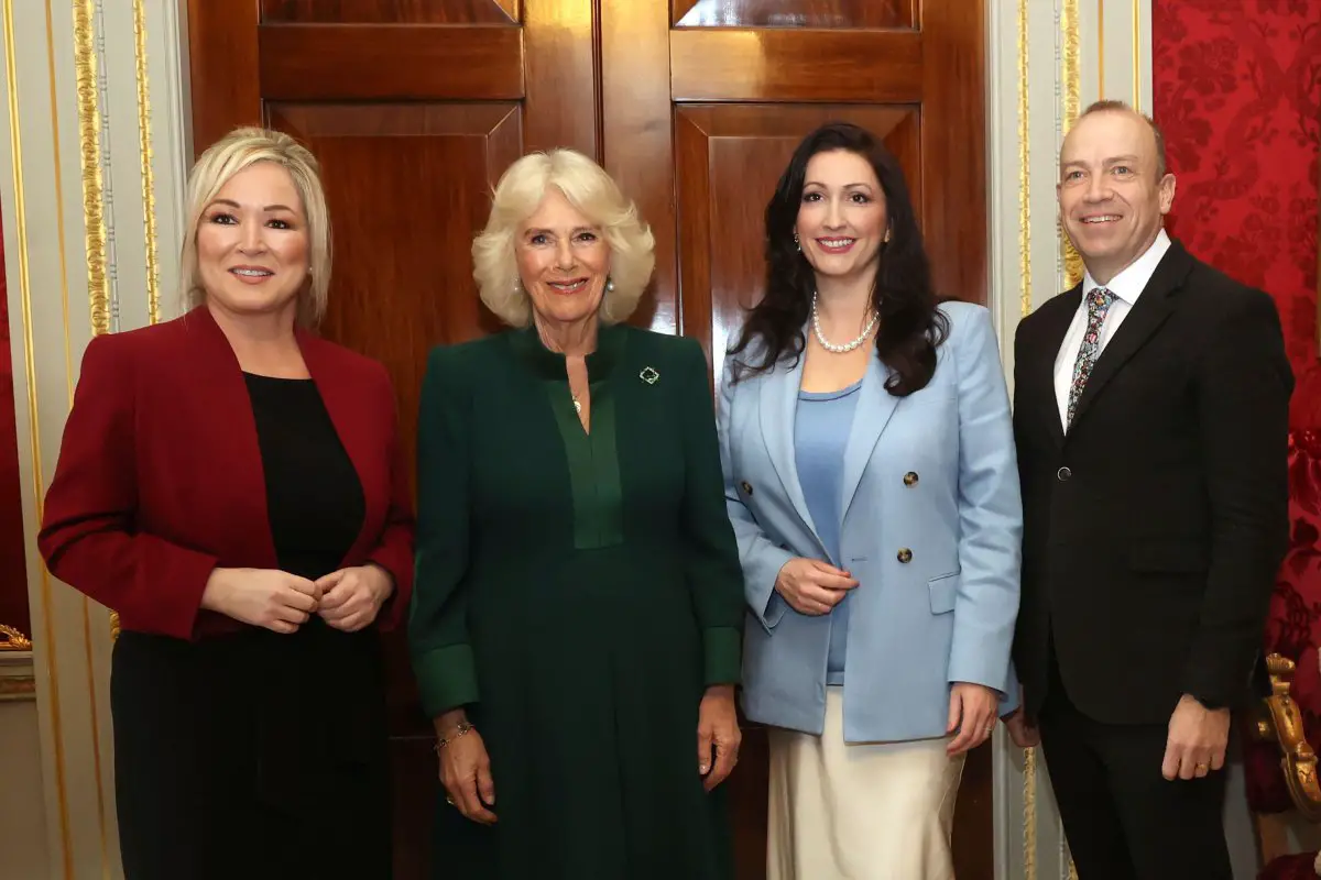 Queen Camilla of the United Kingdom is pictured with First Minister Michelle O'Neill, Deputy First Minister Emma Little-Pengelly, and Northern Ireland Secretary Chris Heaton-Harris during a reception hosted by the Queen's Reading Room to mark World Poetry Day at Hillsborough Castle in Belfast on March 21, 2024 (Liam McBurney/PA Images/Alamy)