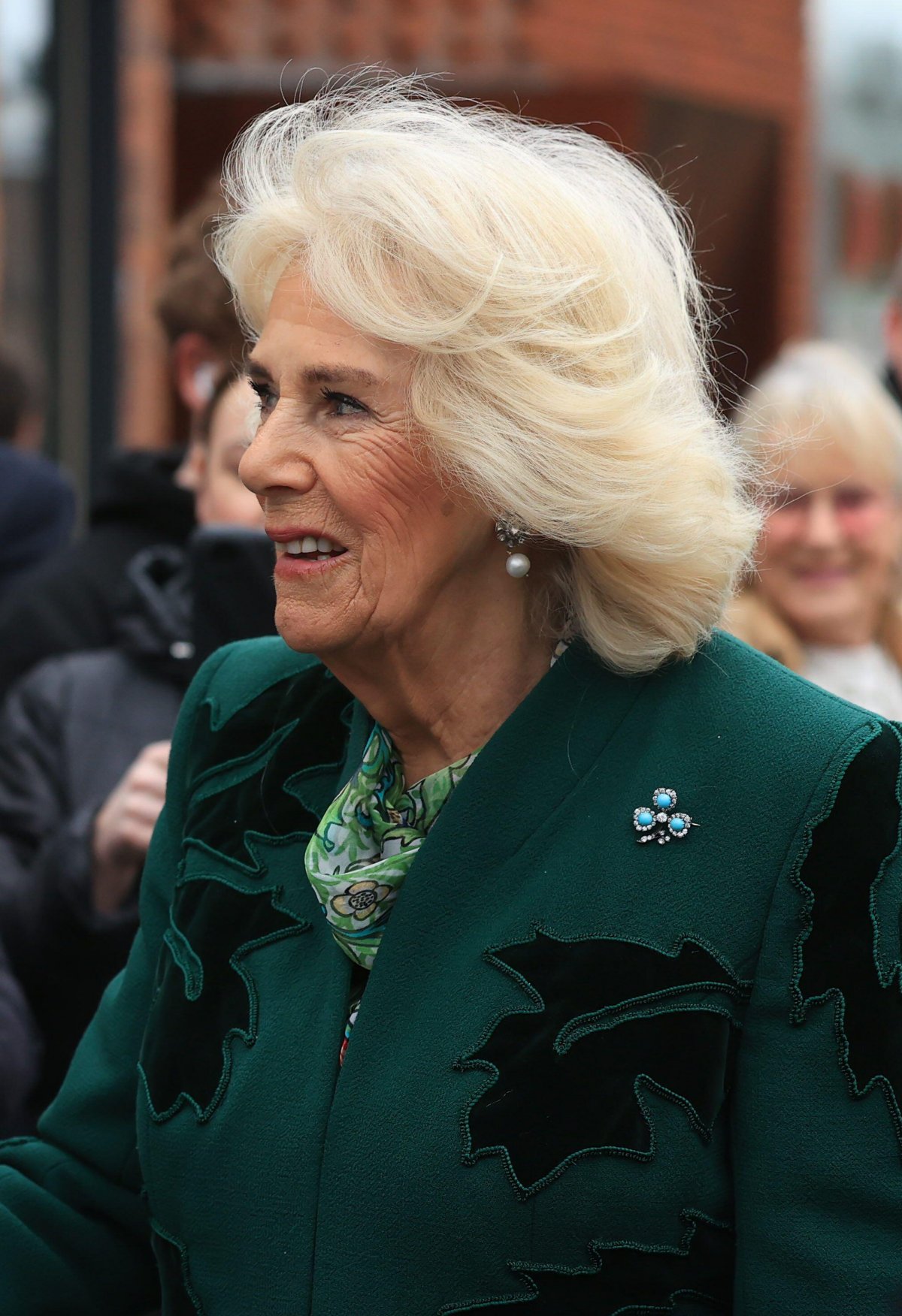 Queen Camilla of the United Kingdom meets members of the community during a visit to Lisburn Road in Belfast on March 21, 2024 (Liam McBurney/PA Images/Alamy)