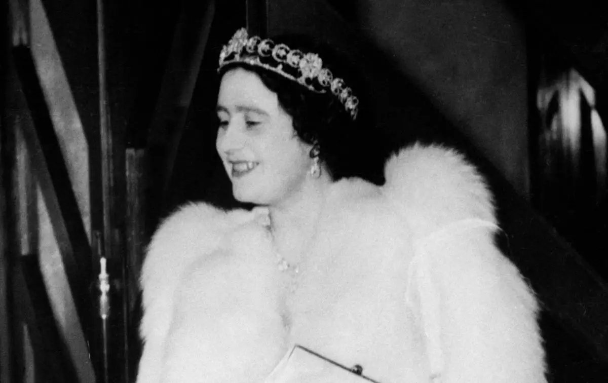 Queen Elizabeth is presented with a bouquet of flowers by Lady Bessborough, the wife of the Earl of Bessborough, Chairman of the Anglo-French Art and Travel Society, at a performance of the French National Theatre 