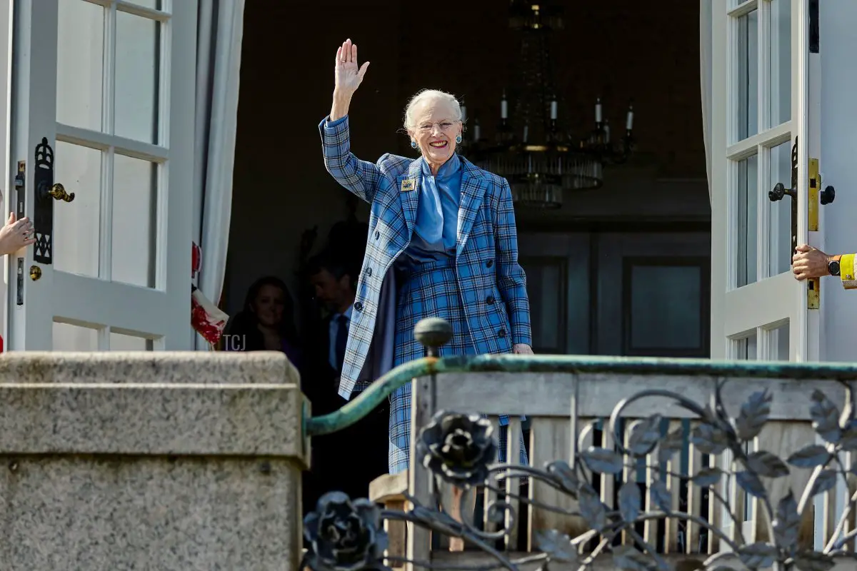 La regina danese Margrethe II saluta i benauguranti dal balcone del Castello di Marselisborg ad Aarhus, Danimarca, il 16 aprile 2022, in occasione del suo 82° compleanno