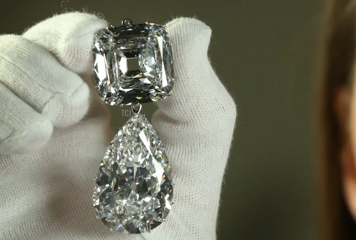 Caroline de Guitaut, Curator of Royal Collections, holds the Cullinan III and IV Broach at The Queen's Gallery, Buckingham Palace on May 15, 2012 in London, England